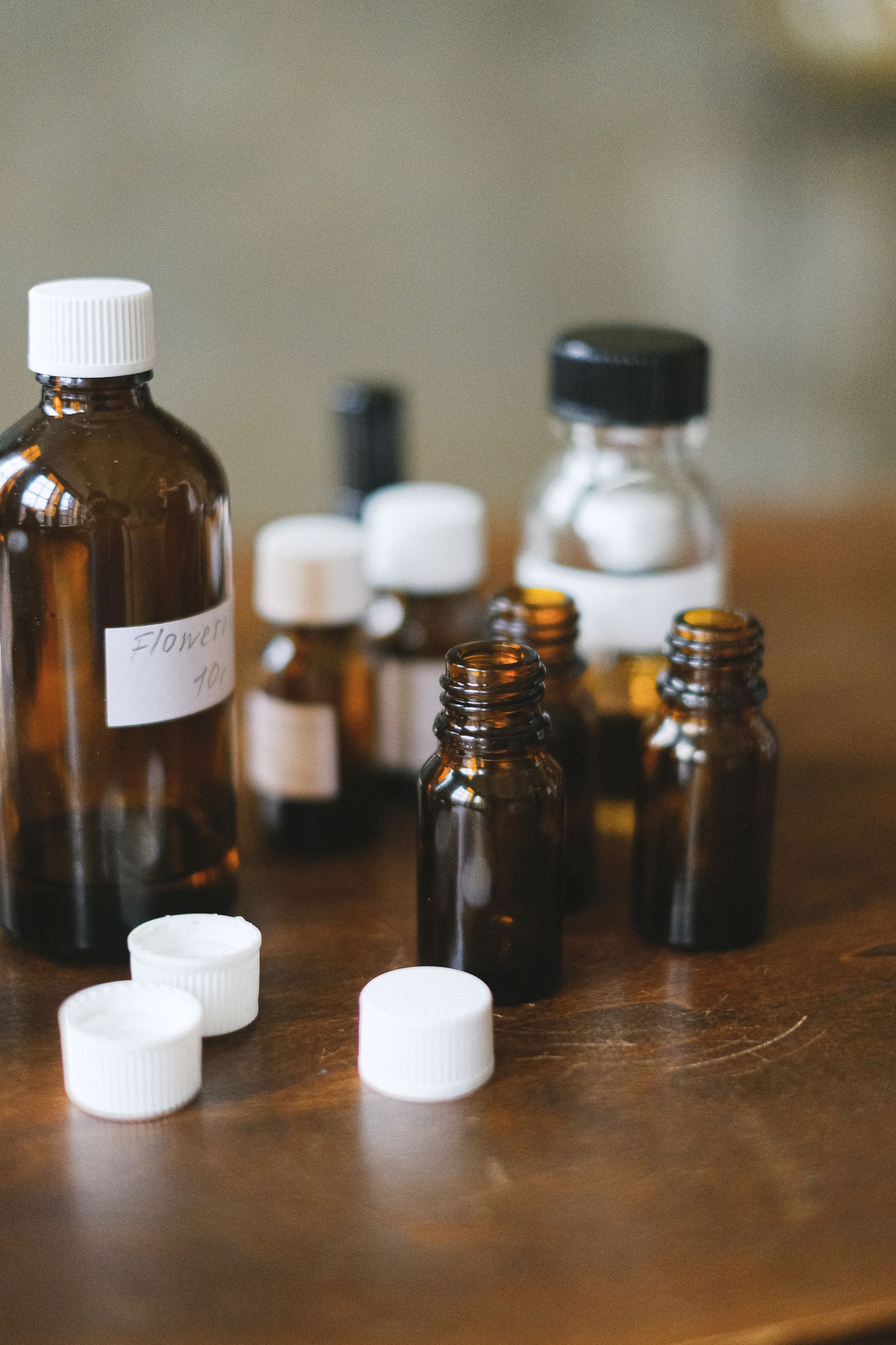 Amber glass bottles with white caps on a wooden table